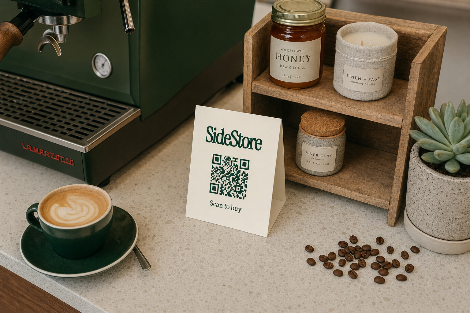 Overhead flat-lay of an independent coffee shop counter with an espresso machine, a small shelf of artisan goods, and a standing ivory SideStore tent card with a navy green QR code beside the products.
