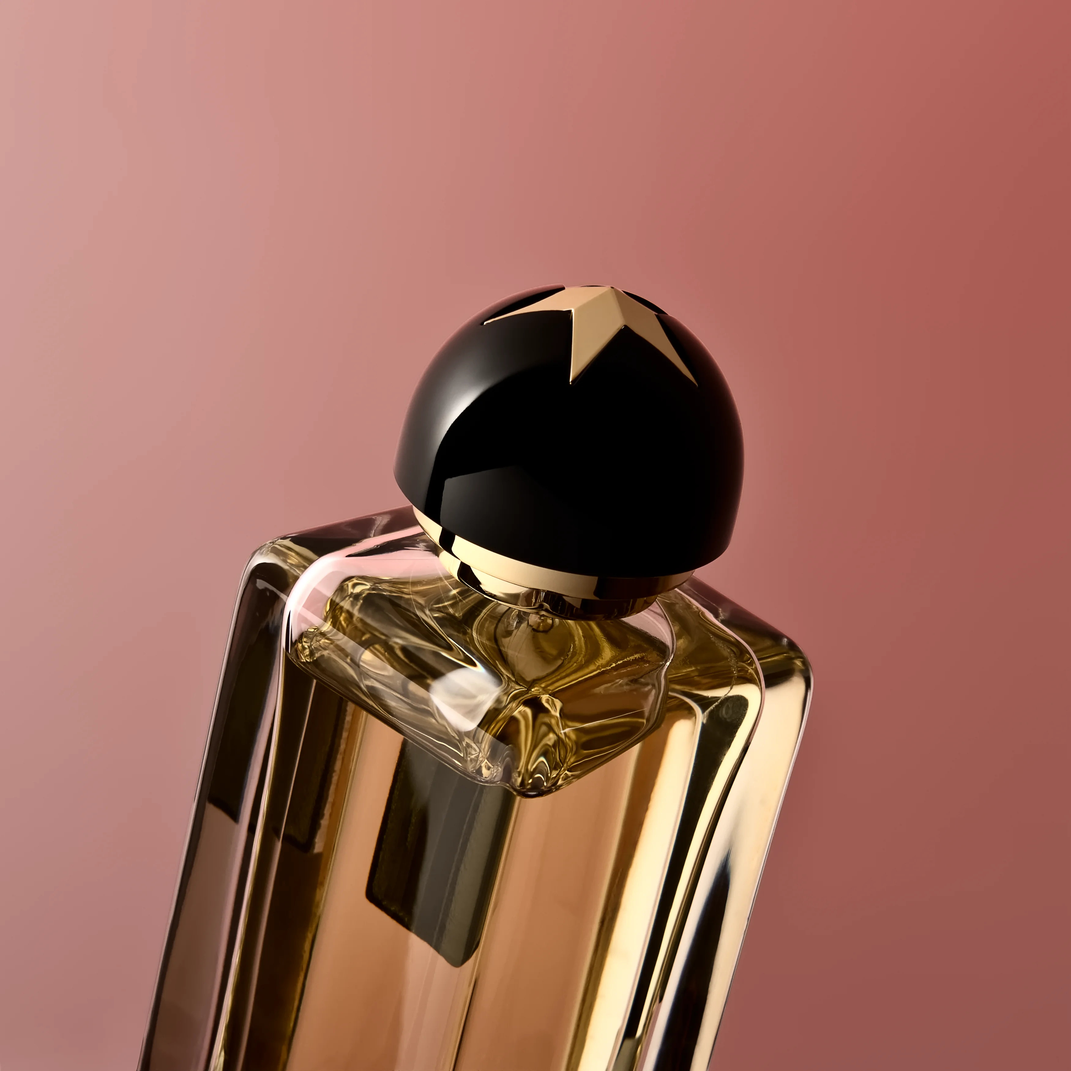 A close view of a flacon star-capped stopper above the faceted shoulder of the bottle